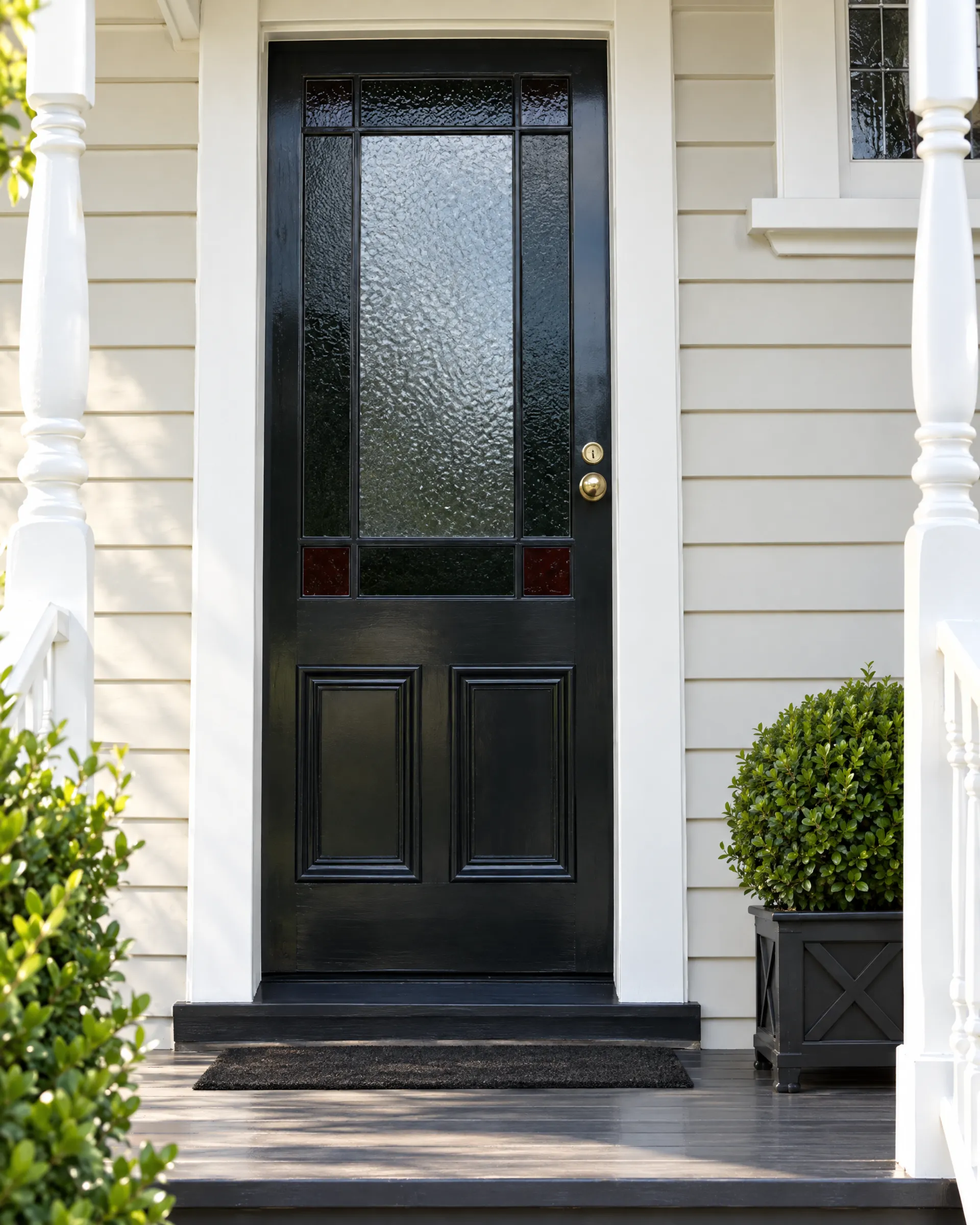 Charcoal timber entrance door with leadlight glazing on a villa
