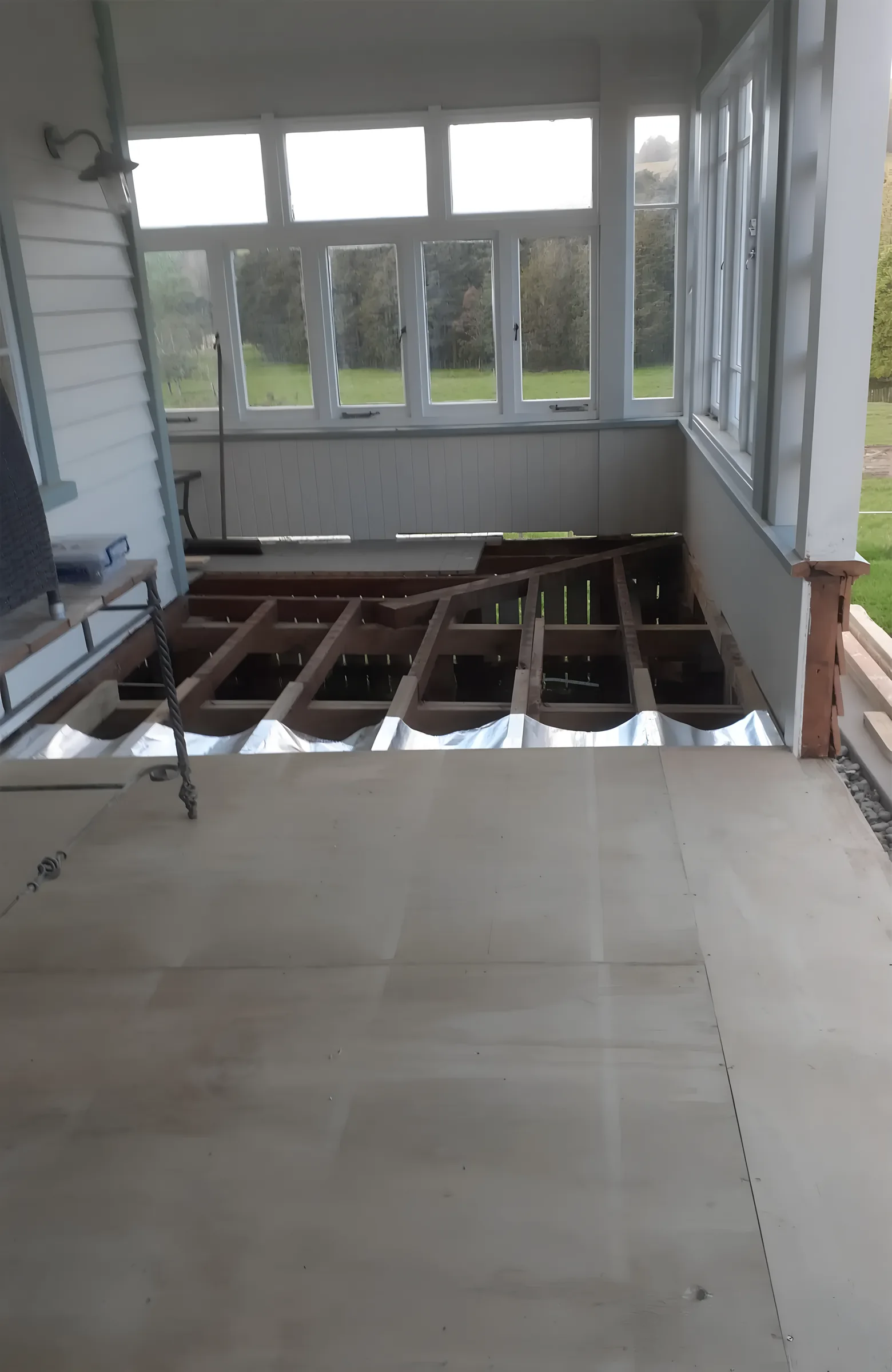 Deck torn up showing the floor joists