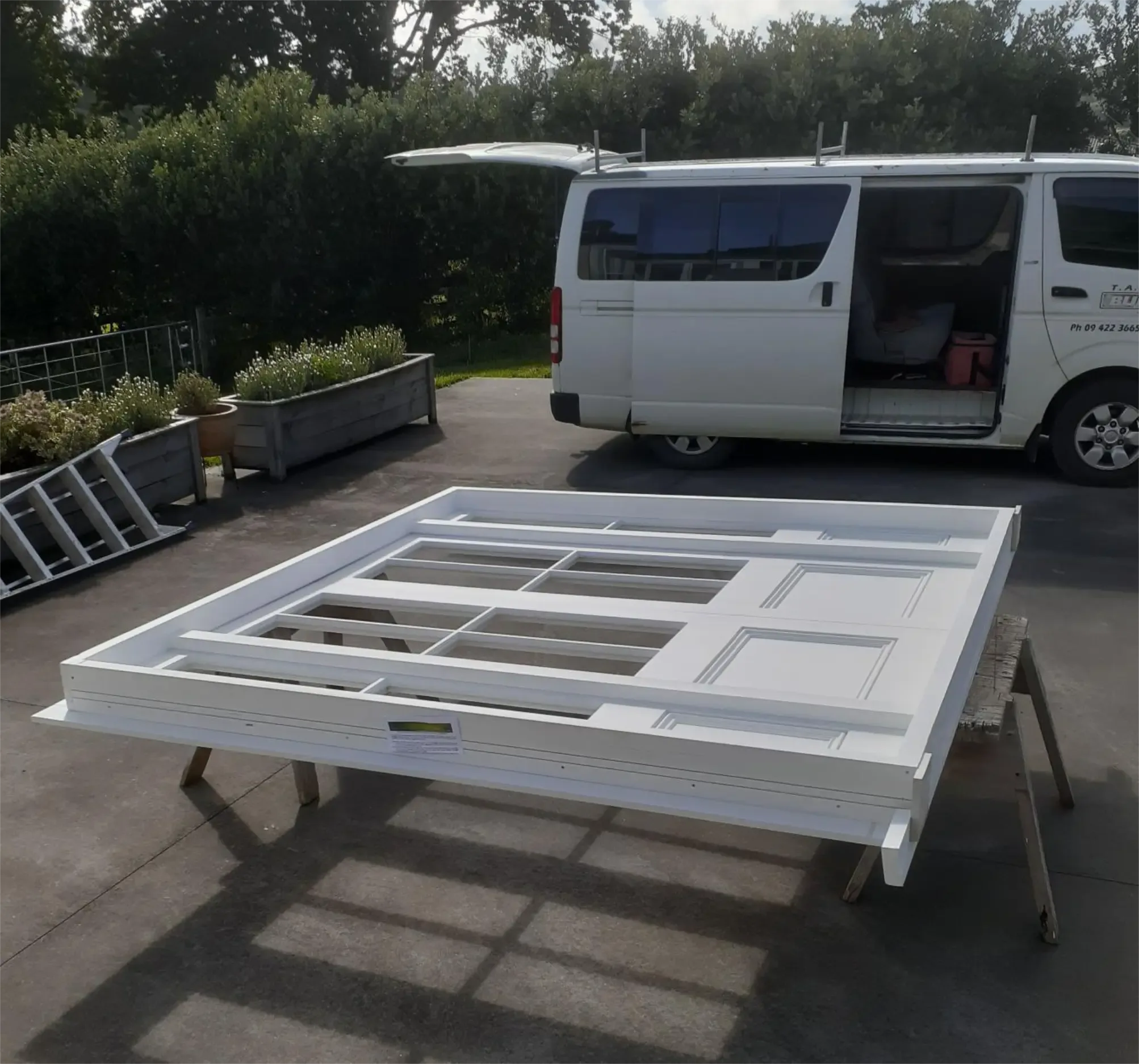 Door being prepared on sawhorses