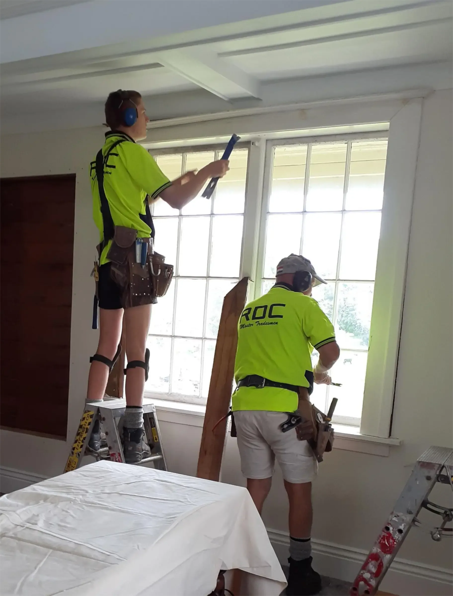 Craftsmen installing French doors