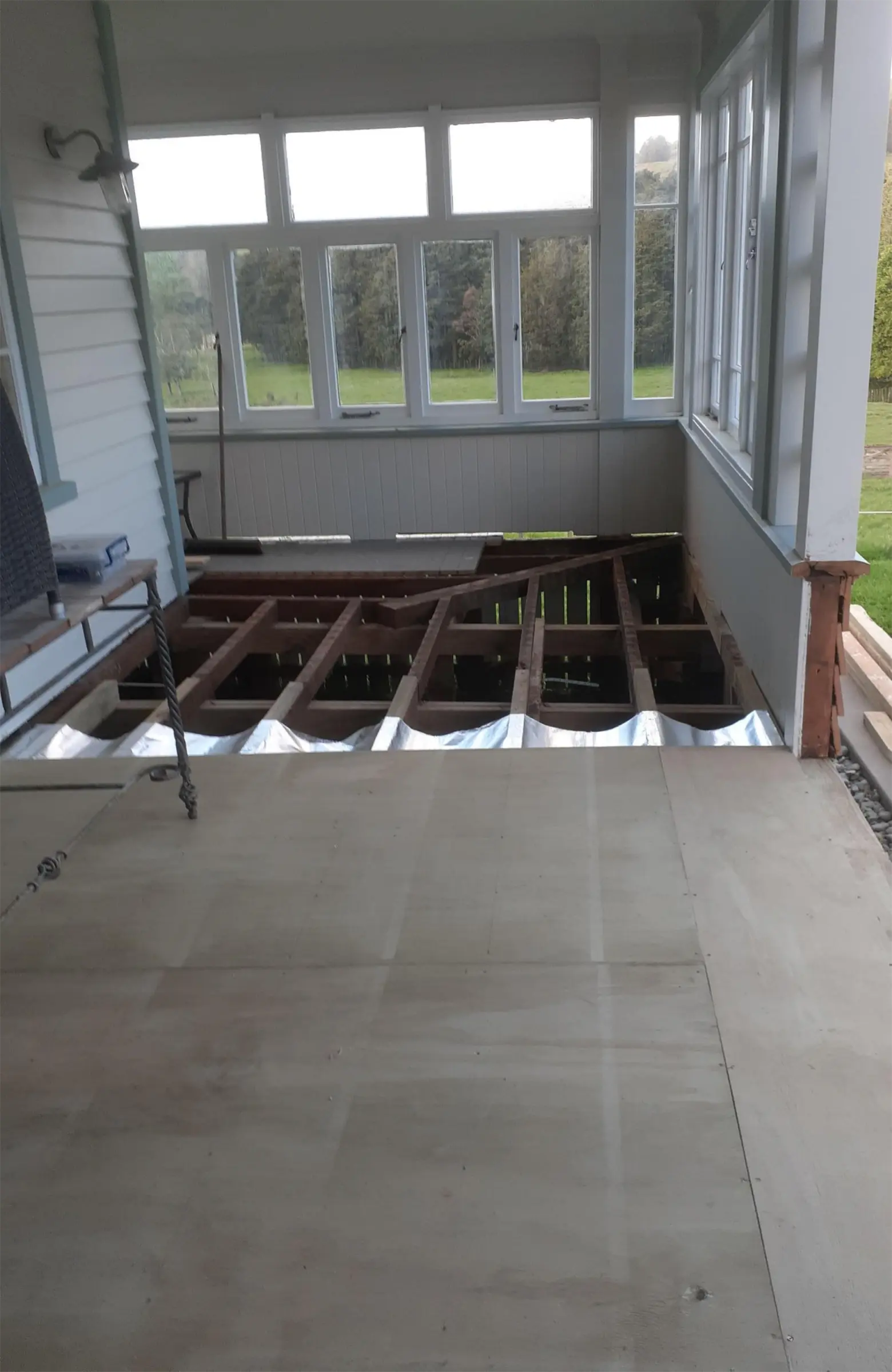 Deck torn up showing floor joists