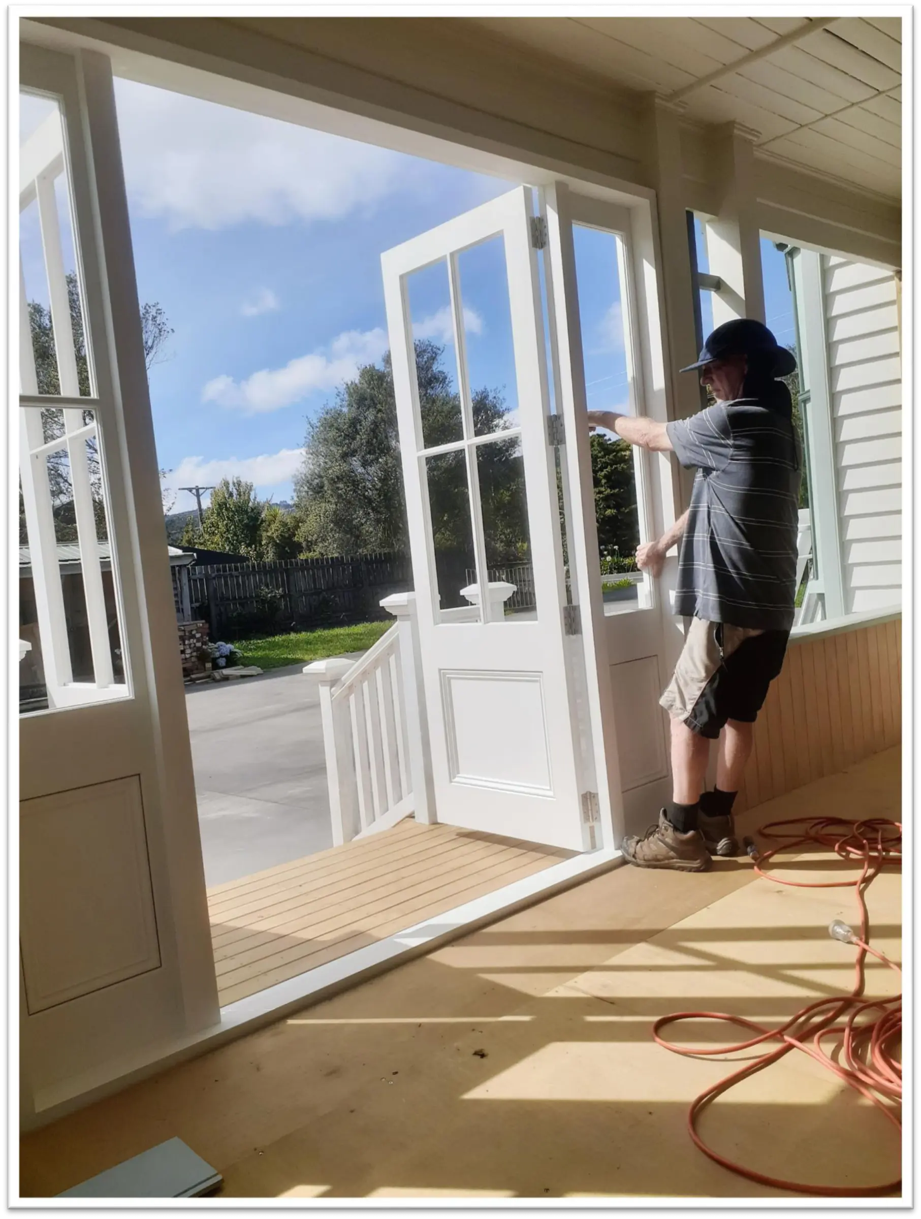 Worker adjusting bifold doors