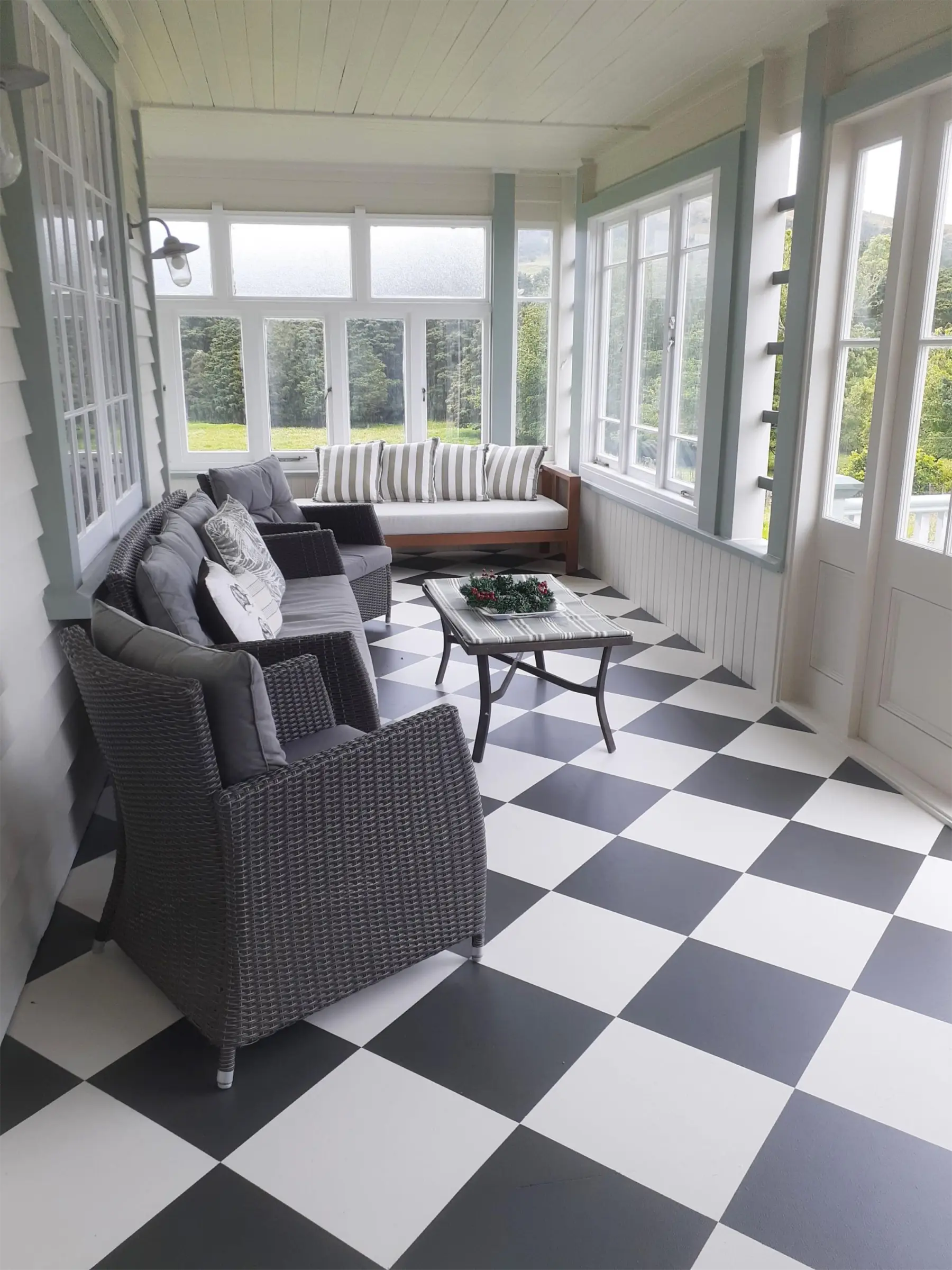 Finished conservatory with checkerboard floor and furniture